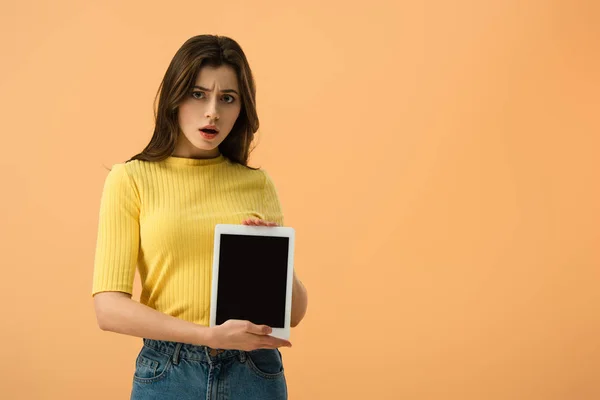 Dissatisfied Brunette Girl Holding Digital Tablet Blank Screen Isolated Orange — Stock Photo, Image