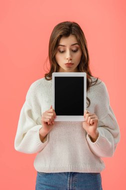 boş ekran üzerinde pembe izole ile dijital tablet tutan sürpriz genç kadın 