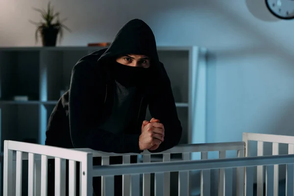 Kidnapper Black Mask Standing Crib Looking Camera — Stock Photo, Image