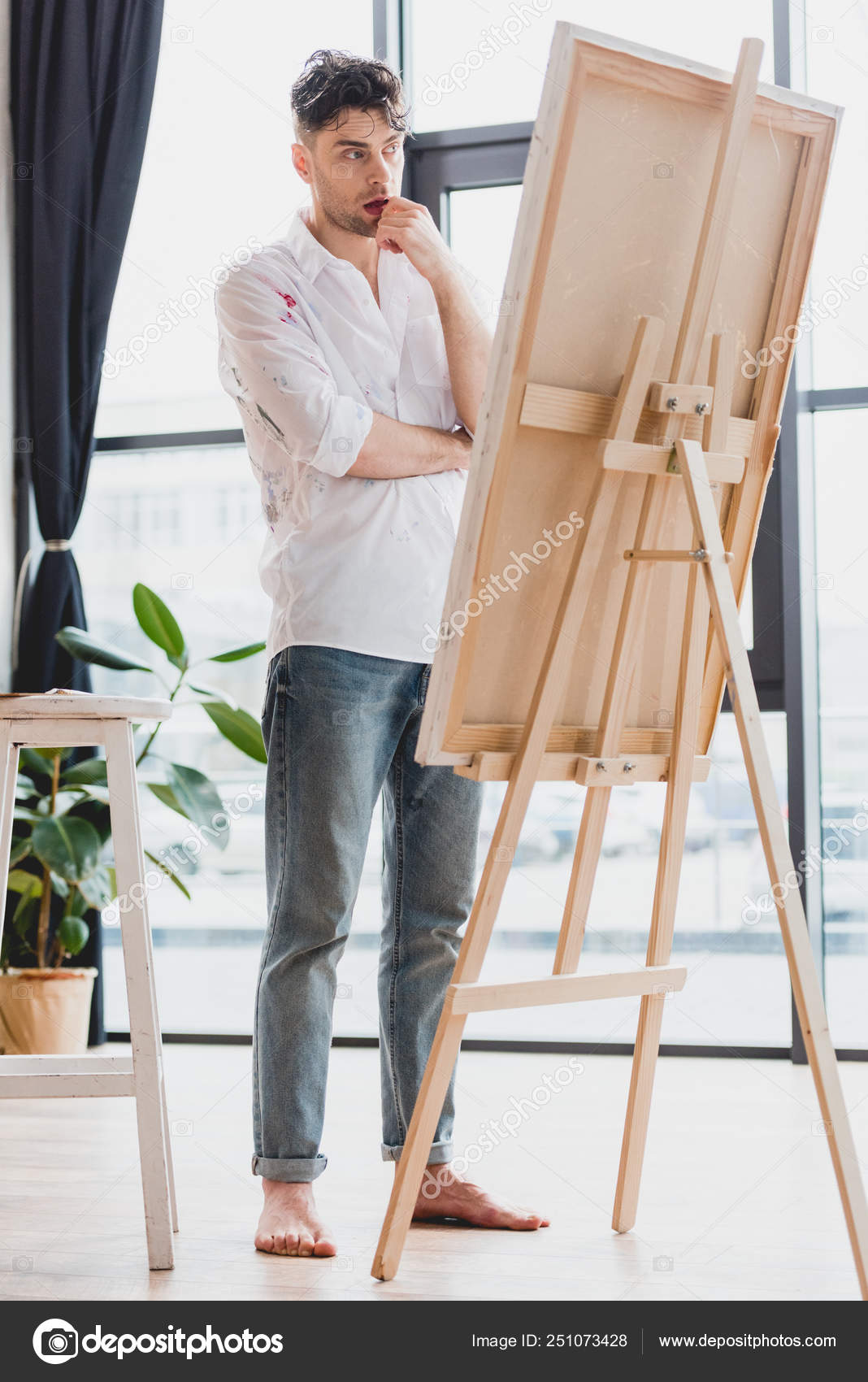 Thoughtful Artist White Shirt Blue Jeans Standing Easel Gallery Stock Photo  by ©AndrewLozovyi 251073428