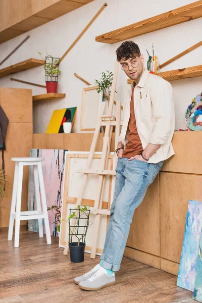 Good Looking Artist Pink Shirt Blue Jeans Standing Painting Studio — Stock Photo, Image