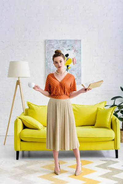 Attractive Elegant Young Woman Holding Book Coffee Cup Living Room — Stock Photo, Image