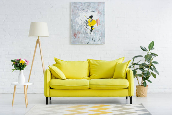 interior of modern white living room with decor and bright yellow sofa