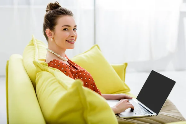 Smiling Elegant Young Woman Pearl Necklace Sitting Yellow Sofa Using — Stock Photo, Image