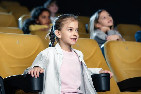 Attentive Smiling Child Watching Movie Cinema Multicultural Friends — Stock Photo, Image