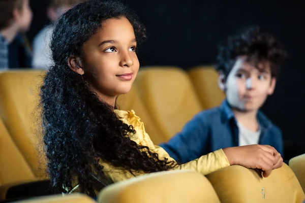 Selective Focus Of Two Multicultural Children Sitting In Cinema And Watching Movie Stock Images Page Everypixel