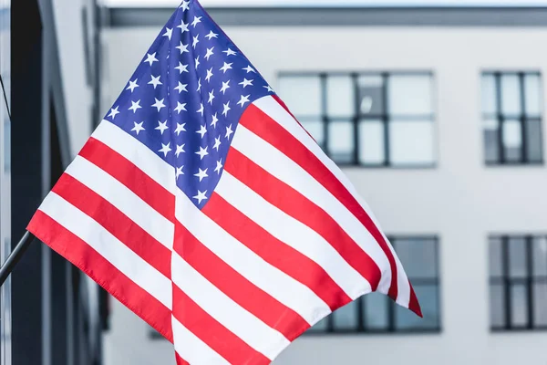 stock image national american flag with stars and stripes near building 