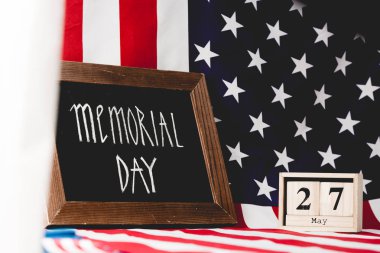 black board with memorial day letters near flag of america and cubes with date clipart