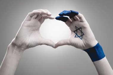 cropped view of female hands with star of david showing heart on grey clipart