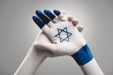 cropped view of female hands with star of david on grey clipart