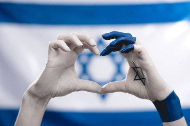 cropped view of female hands with star of david showing heart near flag  clipart
