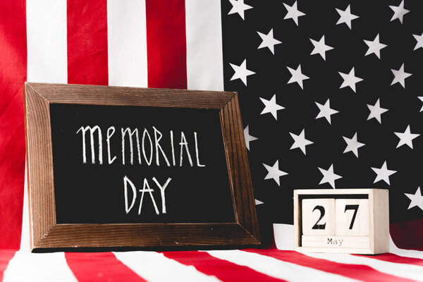 memorial day lettering on chalkboard near cubes with date and flag of america with stars and stripes