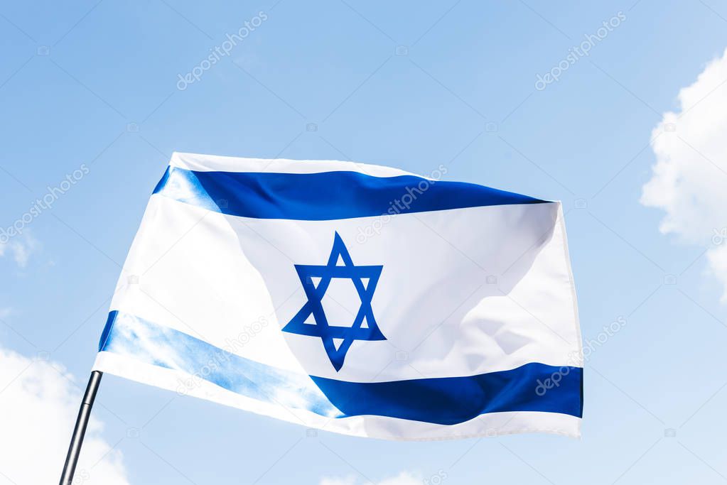 low angle view of national israel flag with blue star of david against sky