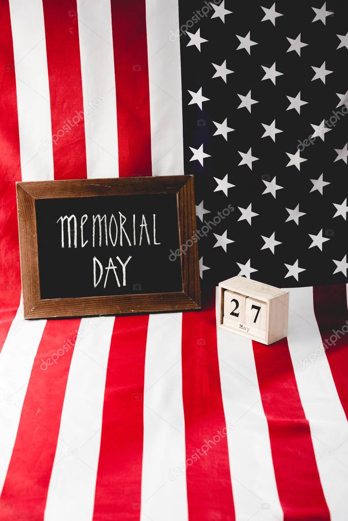 memorial day letters on chalkboard near wooden cubes with date and flag of america 