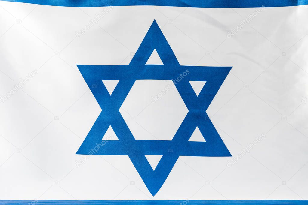 close up of blue star of david on national flag of israel 