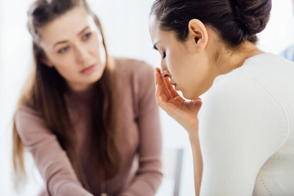 selective focus of woman crying during therapy session