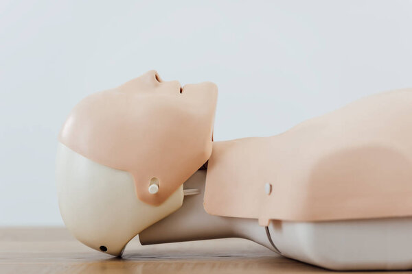 манекен cpr для обучения оказанию первой помощи изолирован на сером фоне
