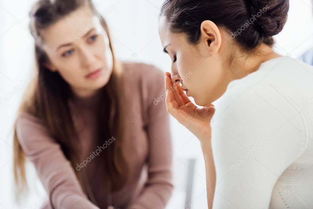 selective focus of woman crying during therapy session