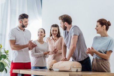 bir grup insan cpr ilk yardım eğitimi sırasında kukla üzerinde performans adam alkış