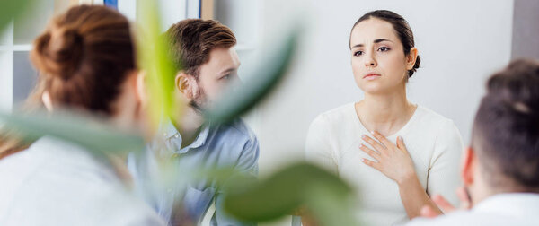 panoramic shot of woman gesturing during group therapy meeting