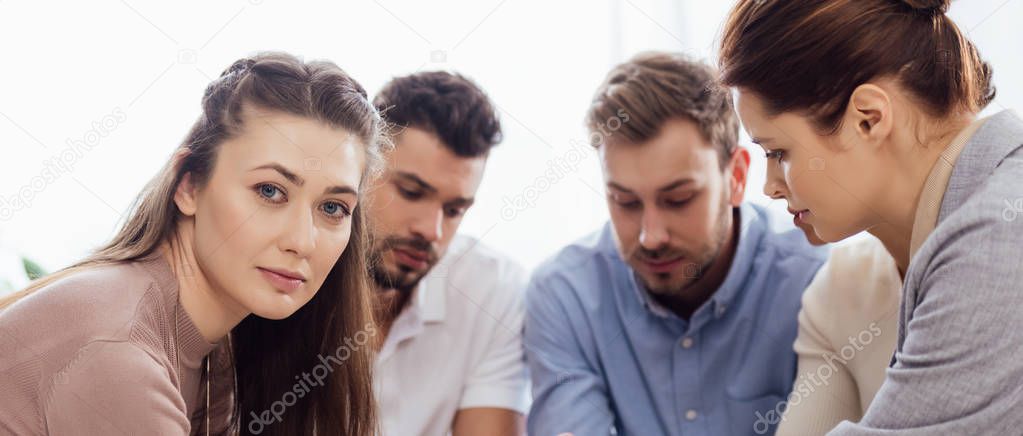 panoramic shot of people during support group session