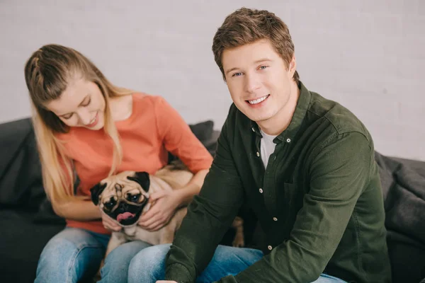 Selective Focus Handsome Smiling Man Sitting Woman Adorable Pug Dog — Stock Photo, Image