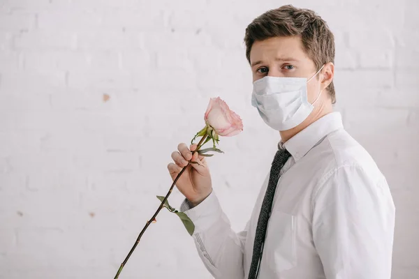 Hombre Máscara Médica Sosteniendo Rosa Mirando Cámara —  Fotos de Stock