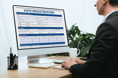 cropped view of man filling in Vote Registration Application Election Concept  clipart