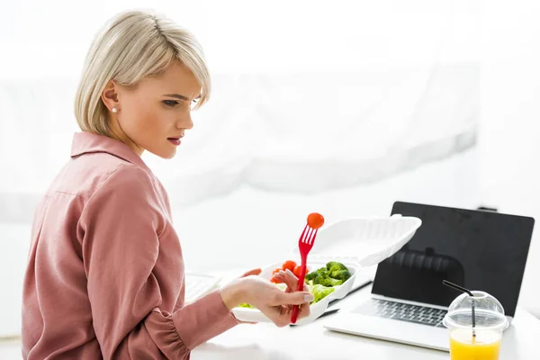 Freelancer Loira Perto Laptop Com Tela Branco Legumes Caixa Takeaway — Fotografia de Stock