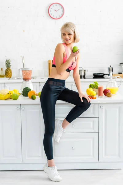 Attractive Woman Sportswear Holding Apple Ingredients Kitchen — Stock Photo, Image