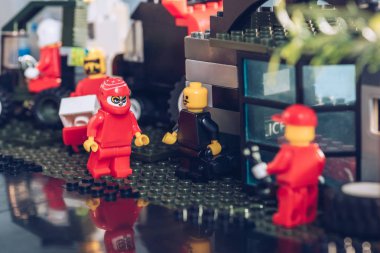 KYIV, UKRAINE - MARCH 15, 2019: Selective Focus of lego minifigures working at service station clipart