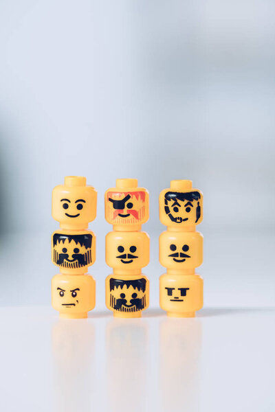 KYIV, UKRAINE - MARCH 15, 2019: yellow heads of lego figurines with various faces in rows