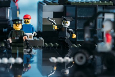 KYIV, UKRAINE - MARCH 15, 2019: pirate with gun and lego figurines during fight scene on lego blocks clipart