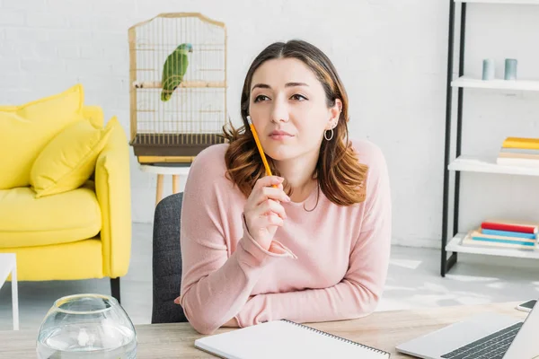 Beautiful Thoughtful Woman Holding Pencil Looking Away While Sitting Table — Stock Photo, Image