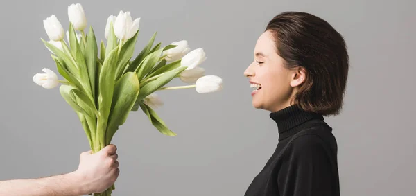 Panoramic Shot Man Holding White Tulips Cheerful Woman Isolated Grey — Stok Foto