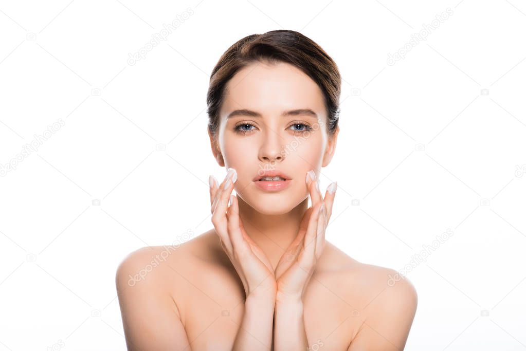 naked brunette woman with face cream in fingers isolated on white 