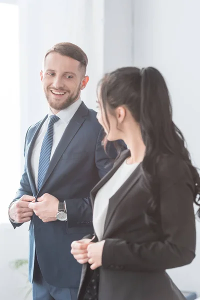Cheerful Bearded Man Looking Brunette Woman While Touching Formal Wear — Stock Photo, Image