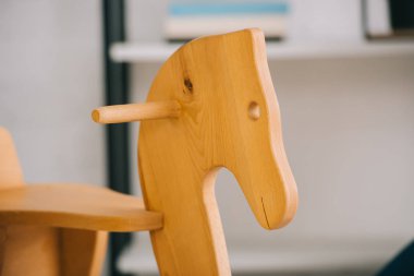 Selective focus of wooden rocking horse in living room clipart