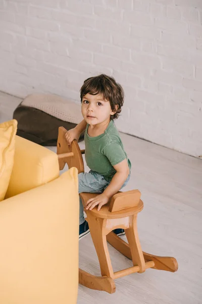 Kid Sitting Wooden Rocking Horse Living Room — Stock Photo, Image