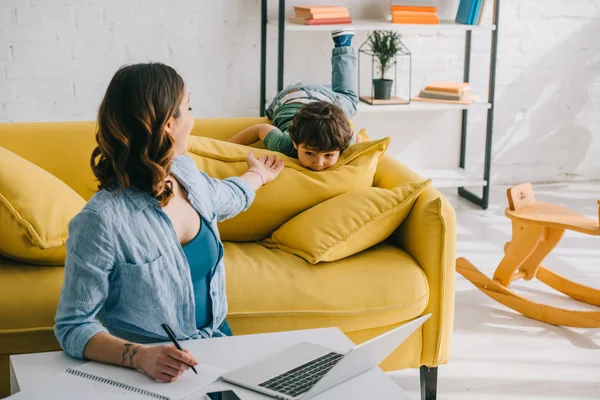 Woman Looking Son While Working Laptop Living Room — Stock Photo, Image