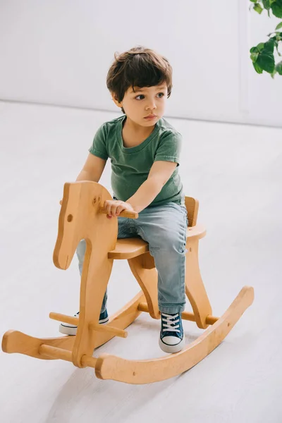 Kid Sitting Wooden Rocking Horse Living Room — Stock Photo, Image