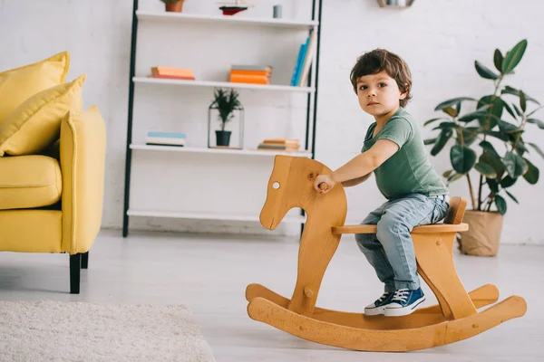 Child Sitting Wooden Rocking Horse Living Room — Stock Photo, Image