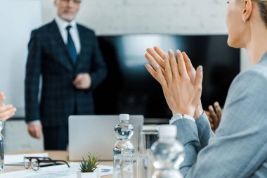 sarışın kadının seçici odak konferans odasında iş koçu alkışlayan 