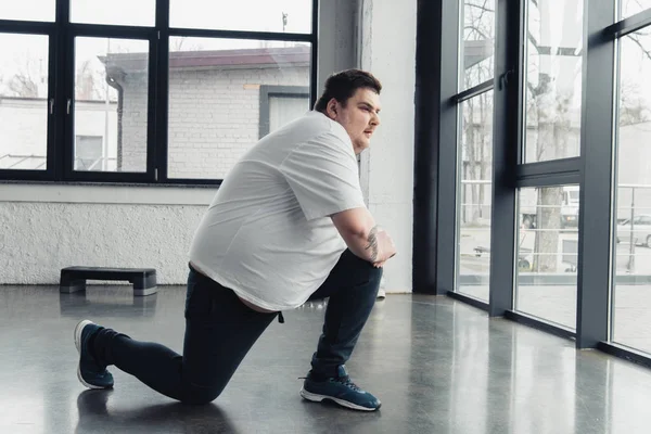 Overweight Man Stretching Legs Sports Center Copy Space — Stock Photo, Image