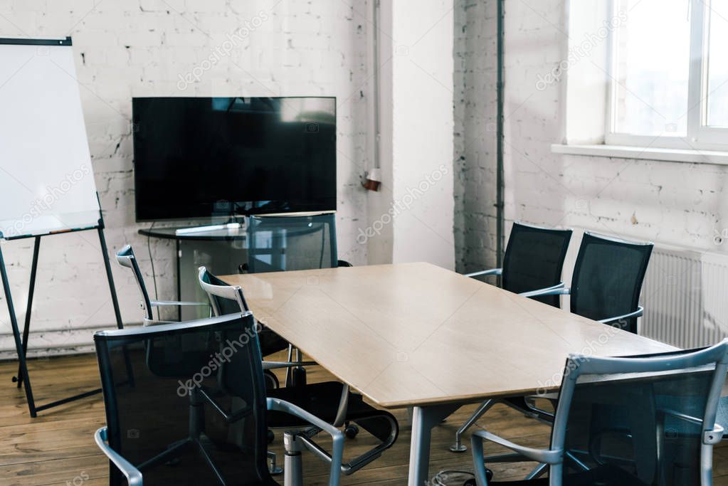 modern conference room with table, chairs, tv screen and white board 