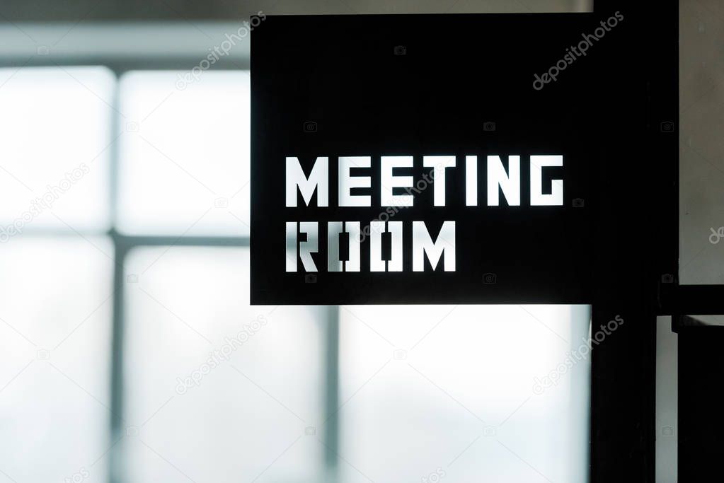 black metallic board with meeting room lettering in modern office 