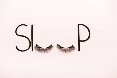 top view of word sleep made with fake eyelashes isolated on beige clipart