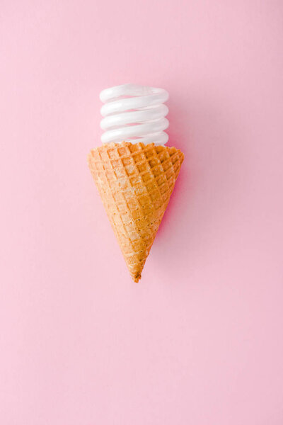 top view of Energy saving lightbulb in ice cream cone Isolated On pink