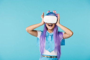 Smiling anime girl in purple wig and vr headset isolated on blue clipart