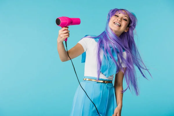 Smiling Asian Anime Girl Wig Using Hairdryer Isolated Blue — Stock Photo, Image